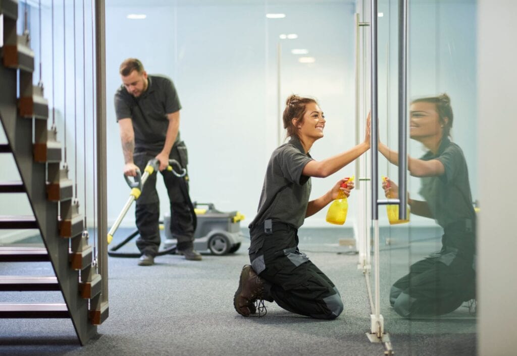 Professional team of commercial and janitorial cleaners cleaning an office