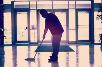 Janitor providing commercial janitorial services in an office building