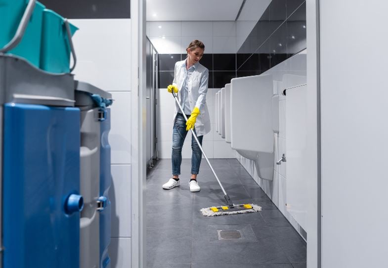 Janitor cleaning an office bathroom in Oshawa
