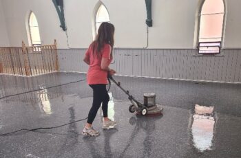 Professional cleaner waxing a floor